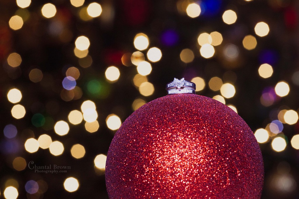 Christmas heard shape wedding ring on red ornament light background
