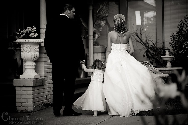 bride and groom with daughter walking at Grey Stone chapel Lawton wedding photographer