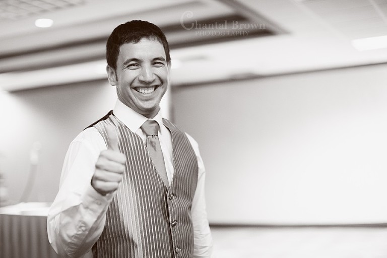 Groom getting ready and smiling at Southfork Ranch wedding in Parker TX