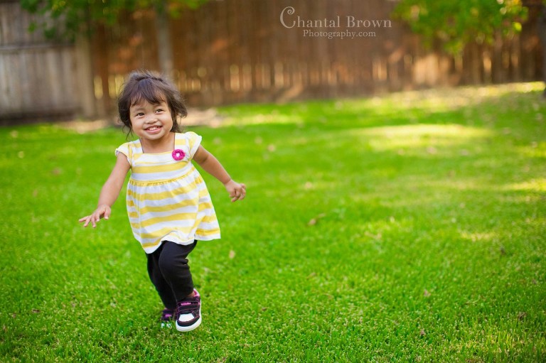 baby running in the park having fun chasing butterflies