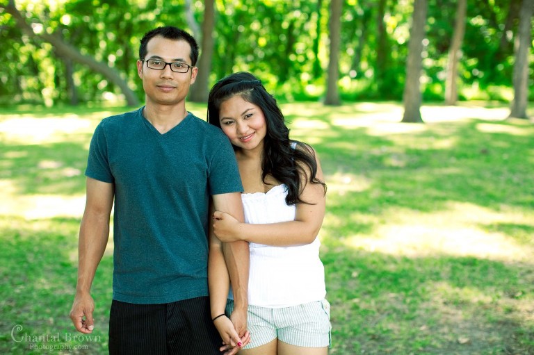 couple hugging and holding hands at the park