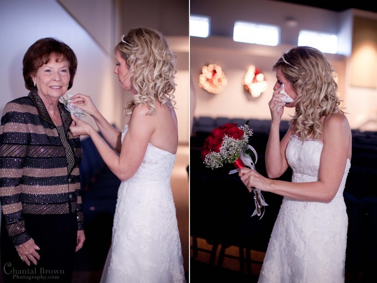 bride putting boutonniere on mother before wedding ceremony