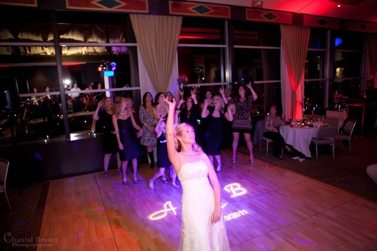 bride tossing boutique to all single ladies on wedding day at Westin Park Central Hotel in Dallas