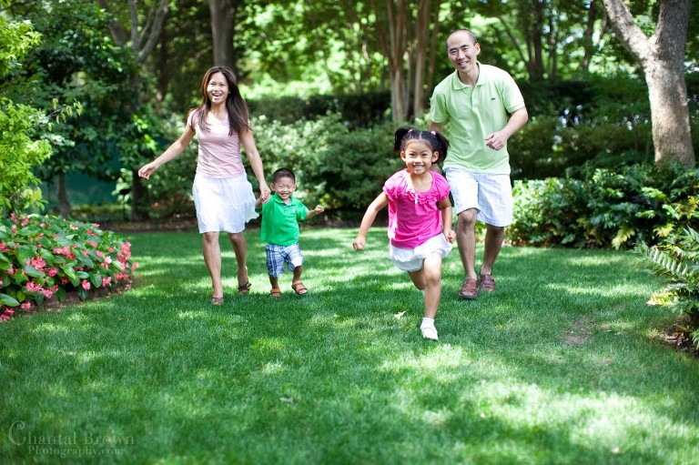 family running happily in Dallas Arboretum greenery grass garden