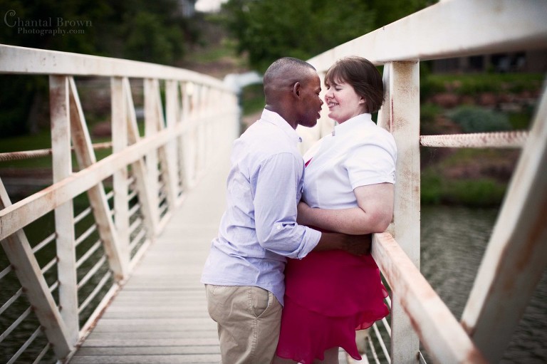 kissing on vintage old white bridge in Medicine Park in Lawton OK engagement portrait