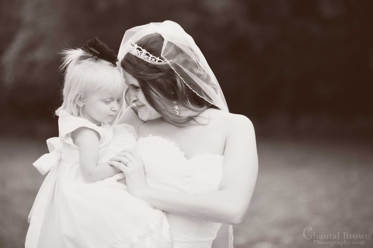 bride smiling at flower girl Holy Family Catholic Church Lawton Oklahoma