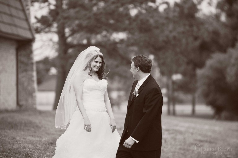 bride smiling at groom first look in Lawton OK black white