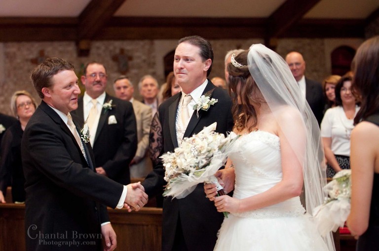 dad giving away bride inside Holy Family Catholic Church Lawton OK