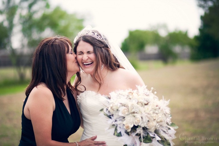 mom kissing bride