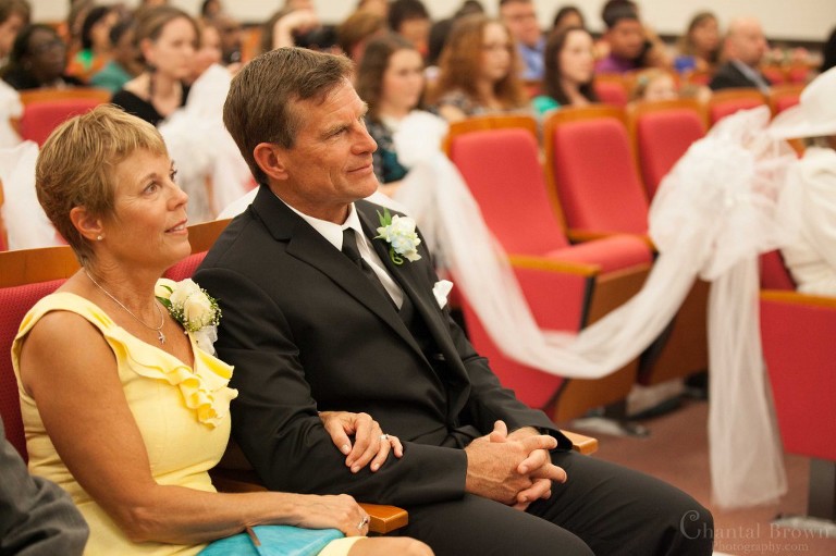 mom dad watching son groom getting married wedding ceremony New Light Methodist Church in Lawton Oklahoma