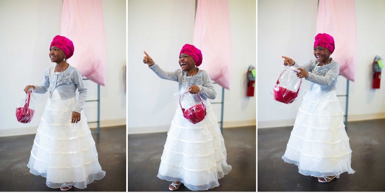 flower girl smiling and pointing at Dallas Filter Building