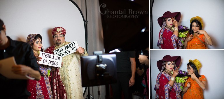 Indian wedding bride and groom having fun in front of photography booth holding funny signs at at Marriott Renaissance hotel in Richardson Texas