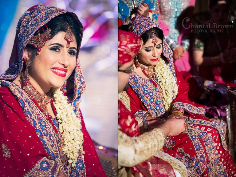Stunning Indian wedding bride and groom exchanging wedding rings wearing traditional red sari fabrics with gold embroidery at Marriott Renaissance hotel in Richardson Texas