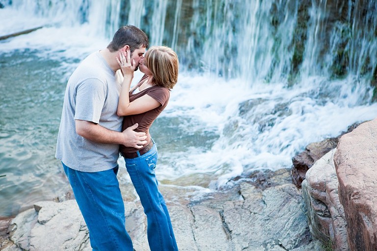 Medicine Park couple kissing by beautiful waterfall engagement in Lawton Oklahoma