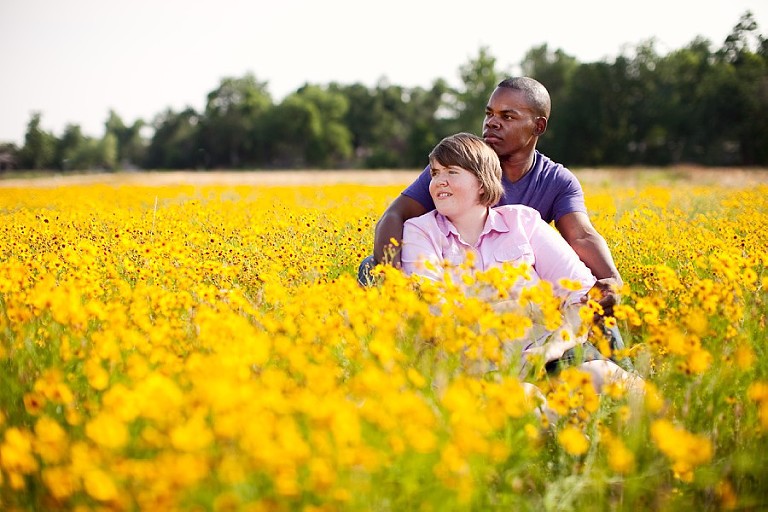 Yellow flowers field engagement couple setting in Wylie Texas photographer
