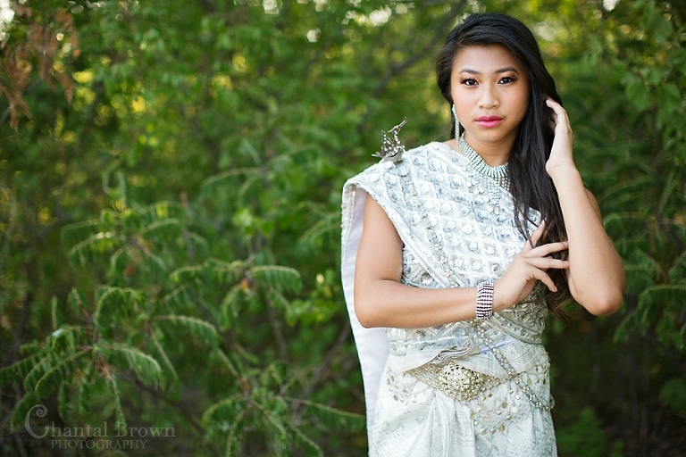 Dallas senior portrait wearing traditional Khmer Cambodian white silver dress at Arbor Hills Nature Preserve Park in Plano Texas