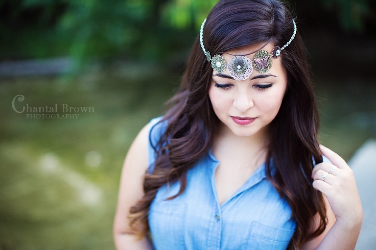 Wylie Texas senior portraits wearing medallion headband by the river in a park