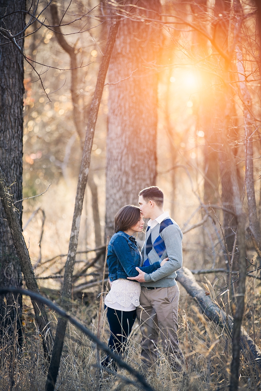Lawton engagement sun flare pictures in the forest by dried tree trunk in fort sill forest by Chantal Brown Photography