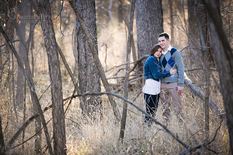 Lawton engagement pictures in the forest by dried tree trunk in fort sill forest by Chantal Brown Photography
