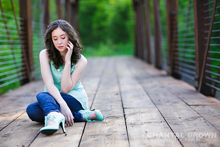 Dallas senior outdoor senior portrait photographer Lucas Christian Academy of Allen TX student setting on a bridge taken by Chantal Brown Photography