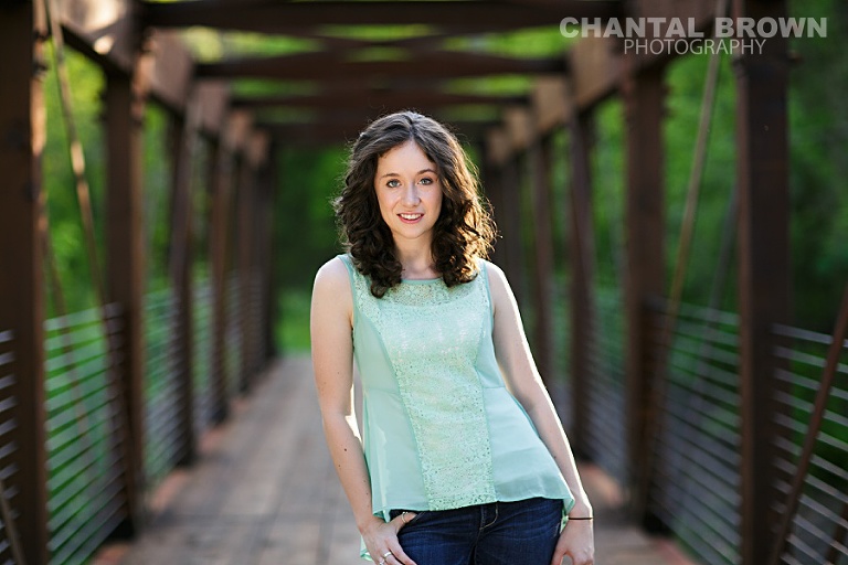 Allen Texas senior outdoor senior portrait photographer Lucas Christian Academy of Allen TX student setting on a bridge taken by Chantal Brown Photography with sun flare
