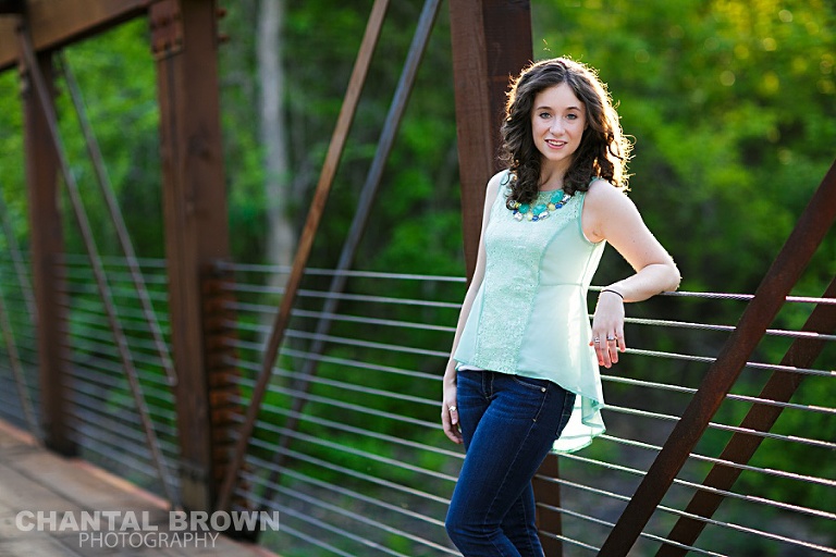 Dallas senior outdoor senior portrait photographer Lucas Christian Academy of Allen TX student setting on a bridge taken by Chantal Brown Photography