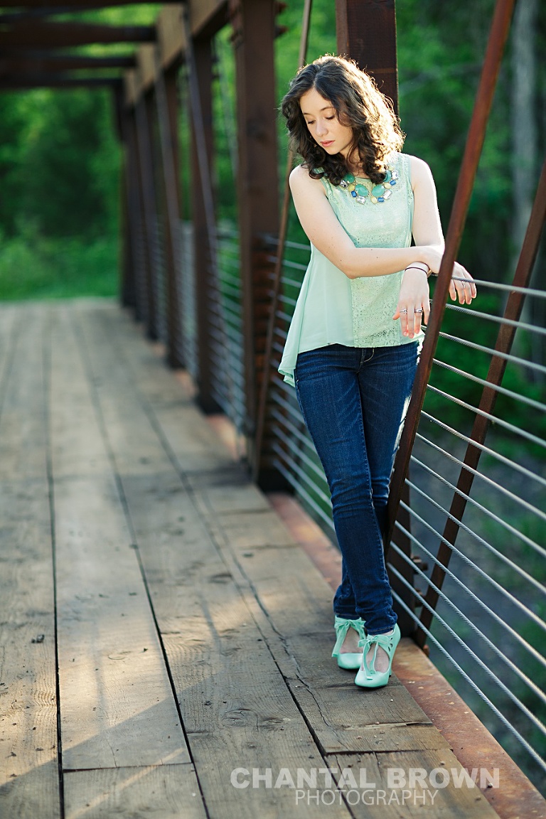 Dallas senior outdoor senior portrait photographer Lucas Christian Academy of Allen TX student setting on a bridge taken by Chantal Brown Photography