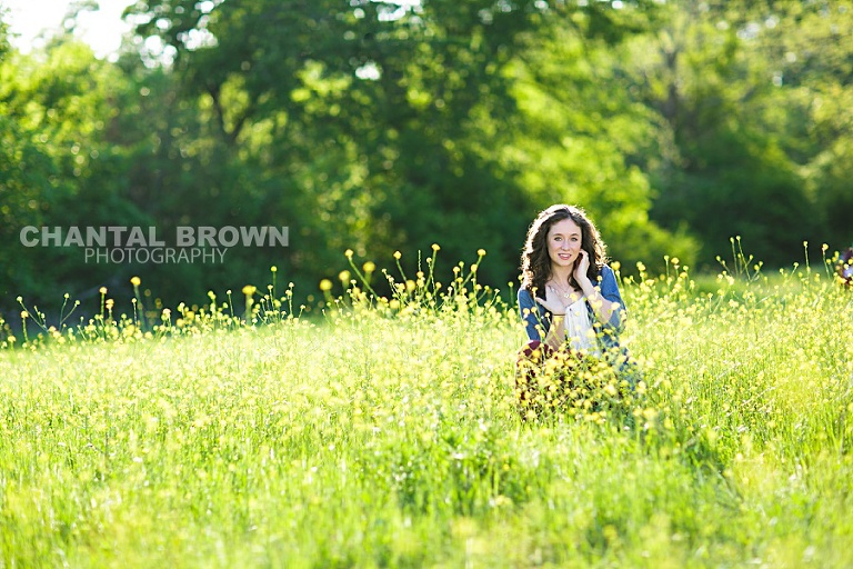 High School student of Lucas Christian Academy of Allen Texas senior portraits is taken in Dallas beautiful yellow flower field in the sun by Chantal Brown Photography