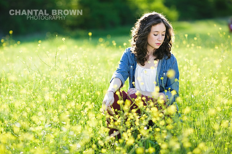 High School student of Lucas Christian Academy of Allen Texas senior portraits is taken in Dallas beautiful yellow flower field in the sun by Chantal Brown Photography
