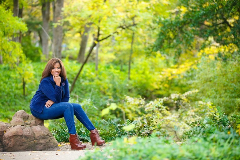 Highland Park Dallas Baptist University college portraits setting on a rock in the fall