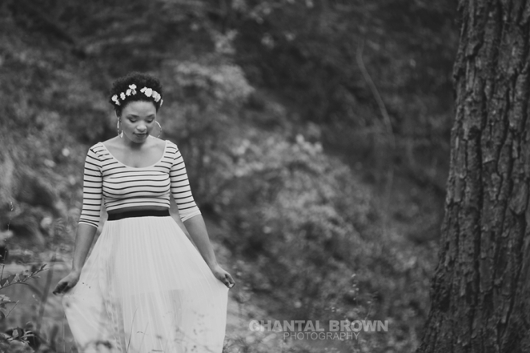Outdoor Red Oak High School senior portraits at Highland Park in Dallas Texas by water creeks and big tall trees with gorgeous flower head band in black and white photo.