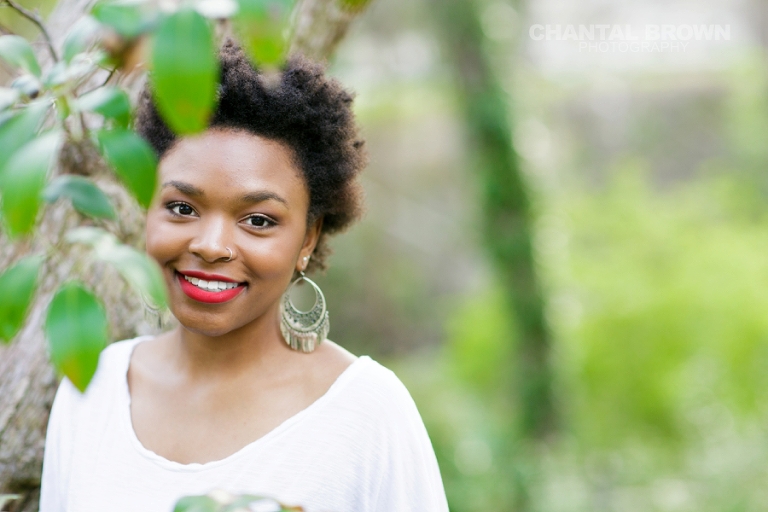 Dallas senior pictures taken at Highland Park Texas standing on a cloud of beautiful grass and surrounded with stunning tall trees.  This Dallas high school senior portraits is taken by Chantal Brown Photography.