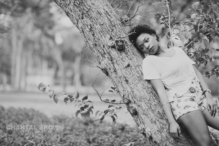 Dallas senior pictures taken at Highland Park Texas leaning on the tree bark.  This Dallas high school senior portraits is taken by Chantal Brown Photography.