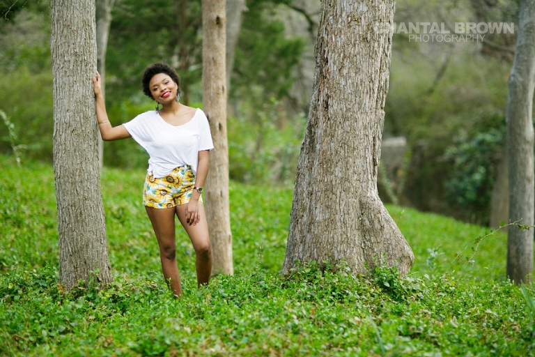 Dallas senior pictures taken at Highland Park Texas standing on a cloud of beautiful grass and surrounded with stunning tall trees.  This Dallas high school senior portraits is taken by Chantal Brown Photography.