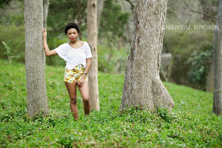 Dallas senior pictures taken at Highland Park Texas standing on a cloud of beautiful grass and surrounded with stunning tall trees.  This Dallas high school senior portraits is taken by Chantal Brown Photography.