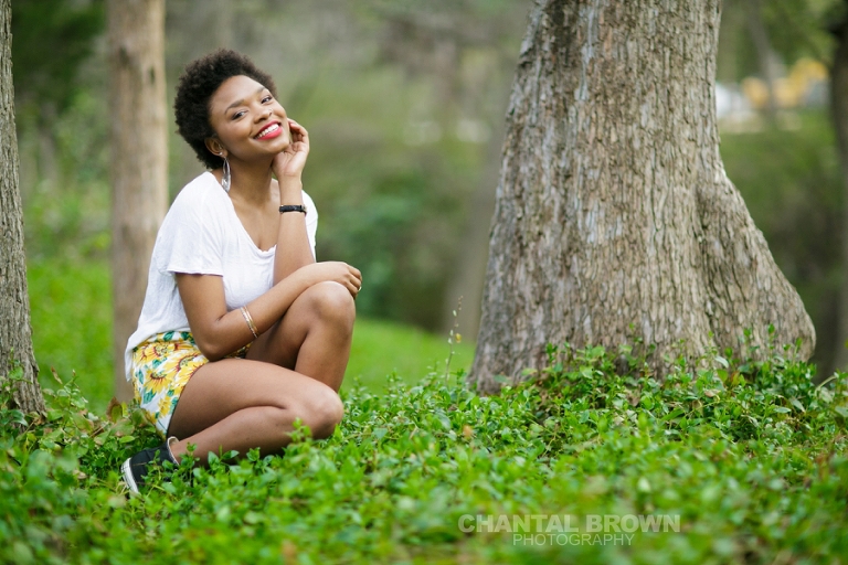 Dallas senior portraits taken at Highland Park Texas setting on a cloud of beautiful grass and surrounded with stunning tall trees.  This Dallas high school senior portraits is taken by Chantal Brown Photography.