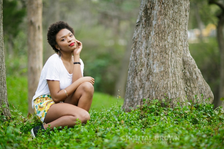 High school Dallas senior pictures taken at Highland Park Texas setting on a cloud of beautiful grass and surrounded with stunning tall trees.  This Dallas high school senior portraits is taken by Chantal Brown Photography.