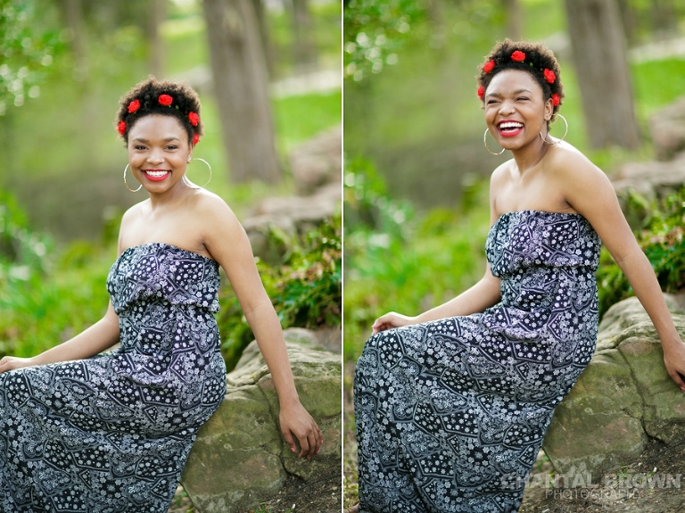 Highland Park Dallas senior pictures of a beautiful high school girl wearing a very pretty red roses head band setting on a big rock laughing really hard and having fun.