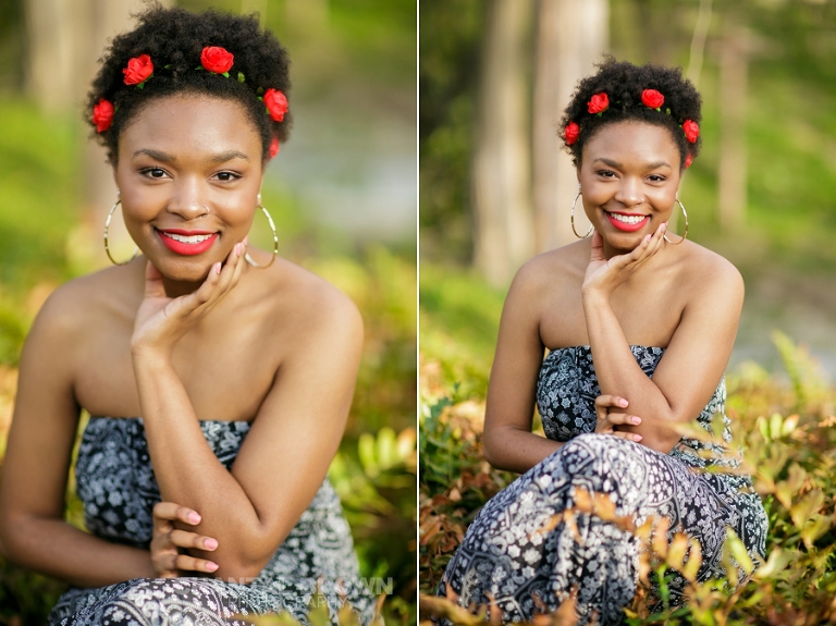 Highland Park Dallas senior portraits of a beautiful high school girl wearing a very pretty red roses head band setting on gorgeous green grass field smiling