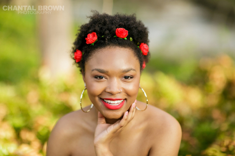 Highland Park Dallas senior portraits of a beautiful high school girl wearing a very pretty red roses head band smiling to the camera