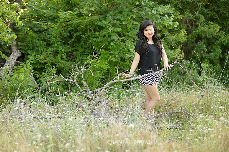 Carrollton Creekview senior portraits of a high school student taken outdoor in greenery grass field.