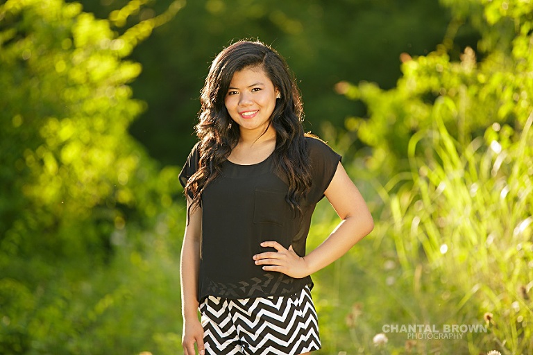 Carrollton Creekview high senior portraits of a high school student taken outdoor with beautiful sunlight as backlight.