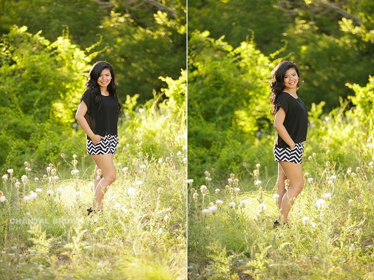 Carrollton senior portrait photographer of a beautiful high school girl taken out in the beautiful green field with pretty back light wearing chevron black and white shorts.