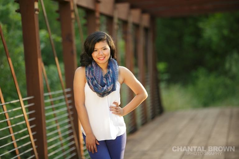 Carrollton Texas senior portraits of Lien taken at Richardson Breckinridge Park standing in the middle of the bridge with her pretty blue scarf by Chantal Brown Photography.