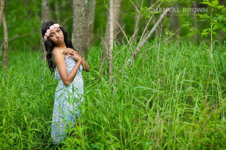 Allen senior portrait of Wylie East high school senior standing in beautiful tall green grass wearing a pink flower head piece and baby blue dress pretending she's in Twilight movie taken by Chantal Brown Photography