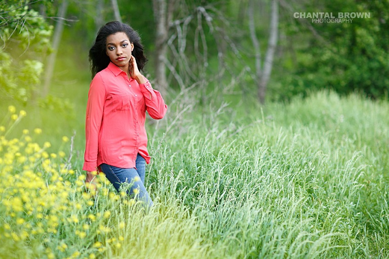 Pretty Wylie East high school senior standing in green and yellow flower field taken by Allen senior portrait photographer of Chantal Brown Photography.