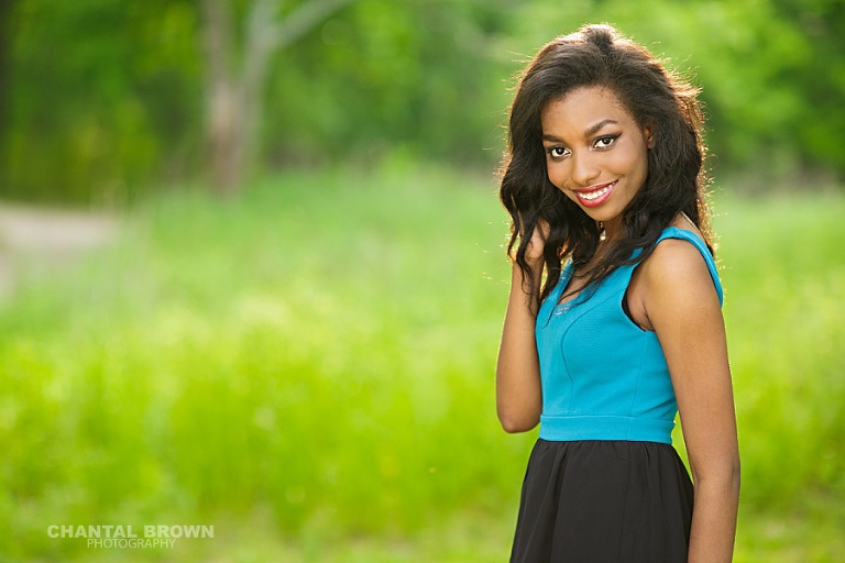 She looks like a Cover Girl smiling to the camera high school student senior portraits taken by Plano senior photography by Chantal Brown Photography in Texas.