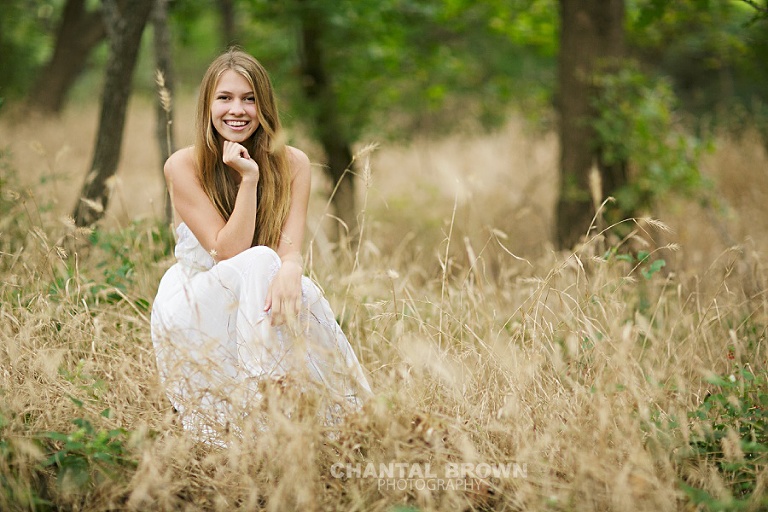 Plano Texas greenhill high school setting in tall grass field by Dallas senior portrait photographer Chantal Brown Photography.