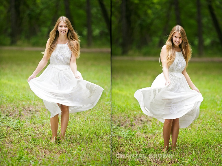 Plano senior picture spinning around in a white dress in the green grass field by Chantal Brown Photography.