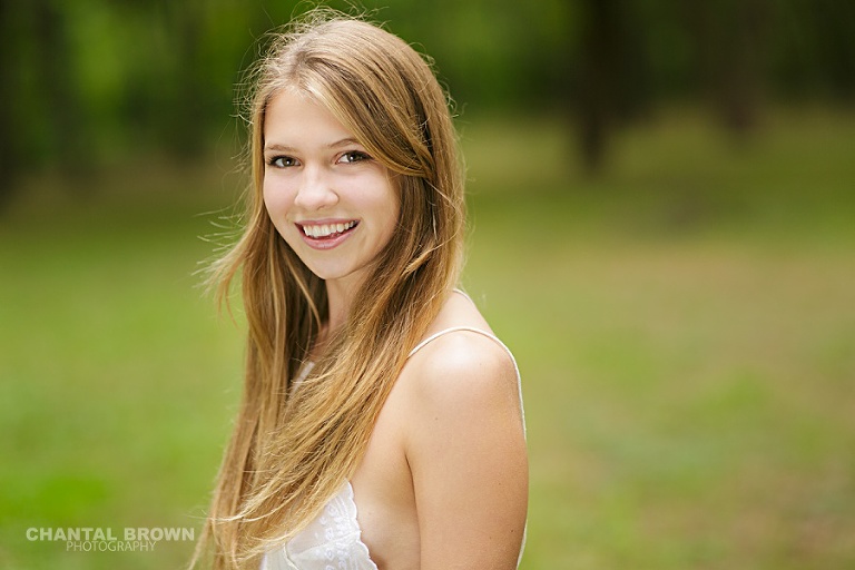 Plano senior portrait photographer smiling by Chantal Brown Photography.